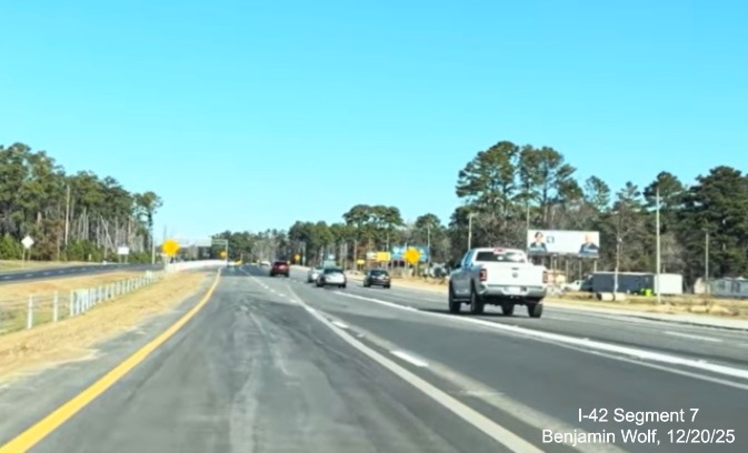 Image of US 70 (Future I-42) West traffic merging with Business 70 West at end
	of US 70 (Future I-42) West Havelock Bypass, Screen grab from Benjamin Wolf video, December 2025