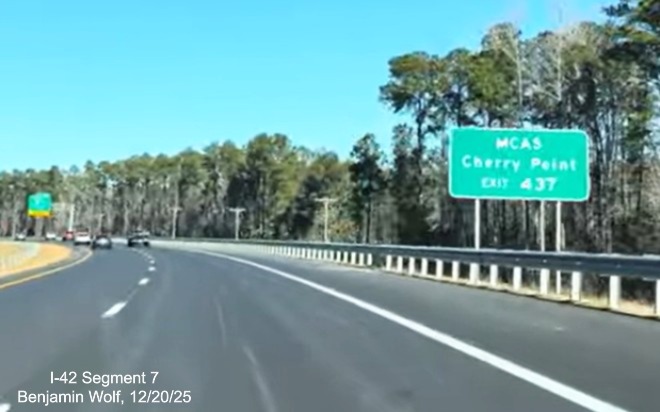 Image of auxiliary sign for West Business US 70 near the beginning of the  
	US 70 (Future I-42) West Havelock Bypass, Screen grab from Benjamin Wolf video, December 2025