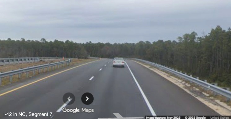 Image of US 70 East beyond the bridge over the future I-42 Havelock Bypass, westbound
	lanes looking complete, Google Maps Street View, November 2025