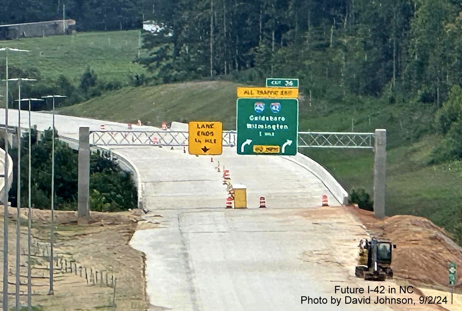 Image of recently placed 1 mile advance overhead sign for I-40/I-42 turbine interchange on yet to open section of NC 540 Toll East Triangle Expressway, by David Johnson, September 2024