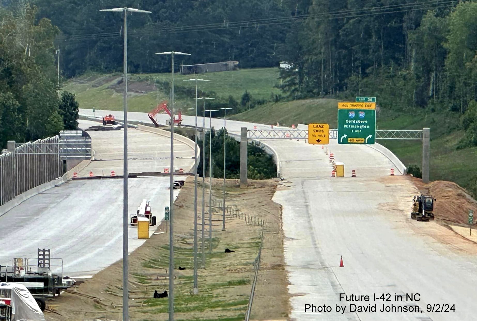 Image of recently placed 1 mile advance overhead sign for I-40/I-42 turbine interchange on yet to open section of NC 540 Toll East Triangle Expressway, by David Johnson, September 2024