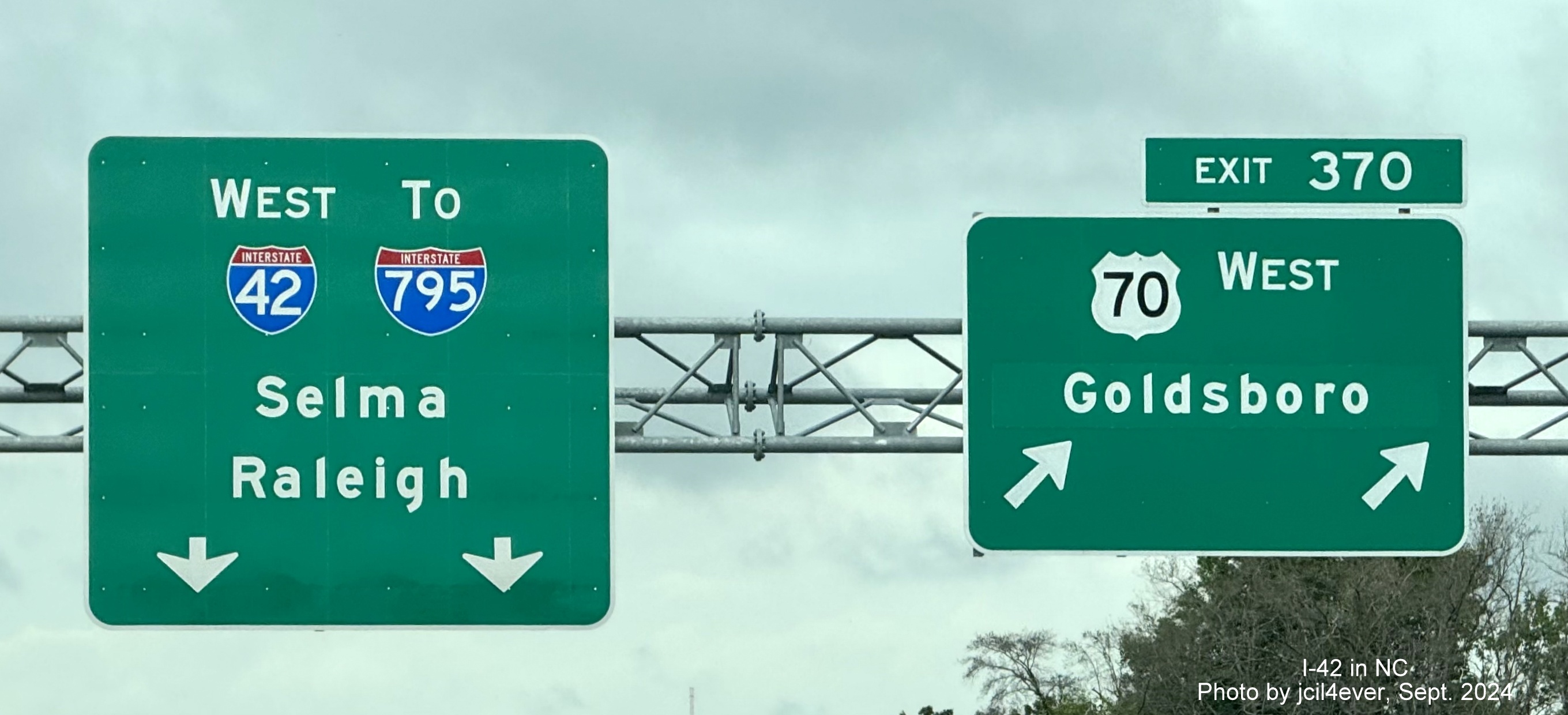 Image of new overhead pull through sign at start of Goldsboro Bypass heading west with new I-42 
         shield, by jcil4ever, September 2024