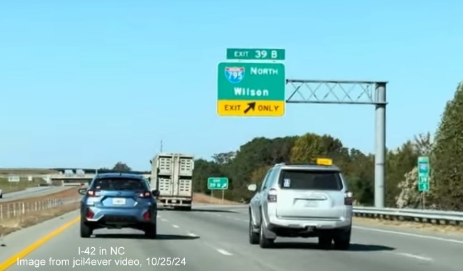 Image of renumbered exit sign for I-795 North exit on I-42 West/Goldsboro Bypass, from jcil4ever video, 
      October 2024