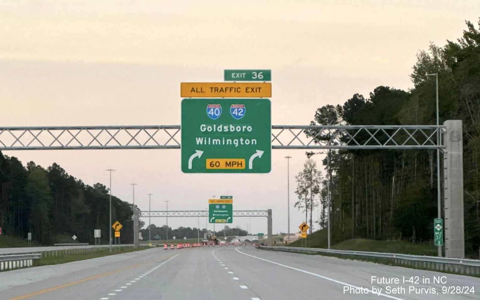 Image of 1/4 mile overhead sign for I-40 and I-42 exits from current end of NC 540/Triangle Expressway at 
        the Turbine Interchange, by Seth Purvis, September 2024