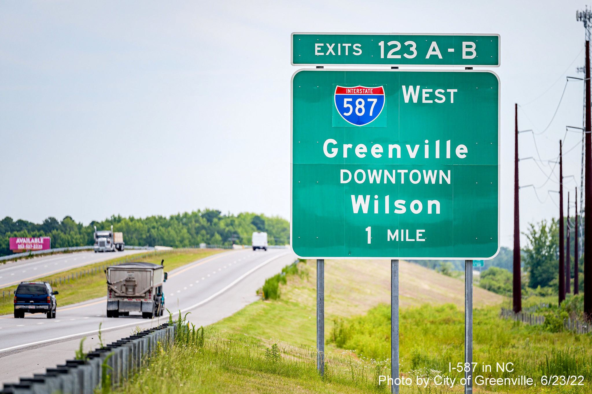 Image of new I-587 shield on 1 mile advance former US 264 exit sign on NC 11 North Bypass in Greenville, by City of Greenville June 2022