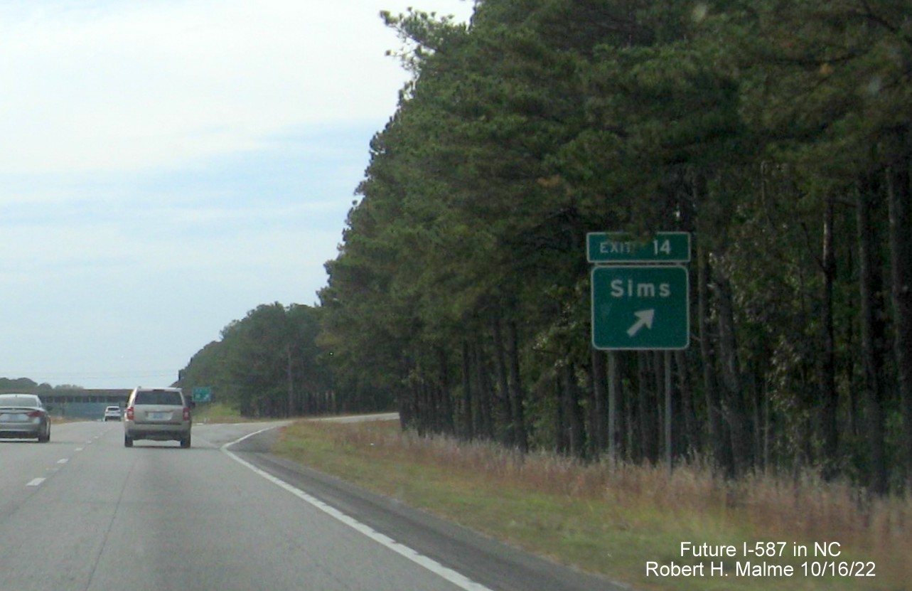 Image of ground mounted ramp sign for Sims exit on US 264 West with new Future I-587 mileage exit number, October 2022