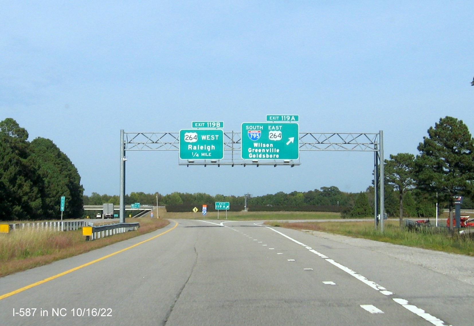 Image of overhead ramp signs for I-587/I-795/US 264 exit not updated to include I-587 shield on I-95 North 
                                       in Wilson,October 2022