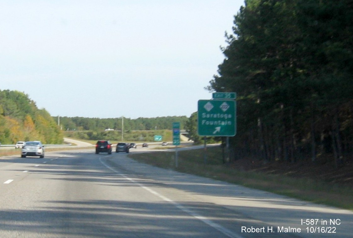 Image of ground mounted ramp sign for NC 111/222 exit with new I-587 milepost exit number on I-587 East in Saratoga, October 2022