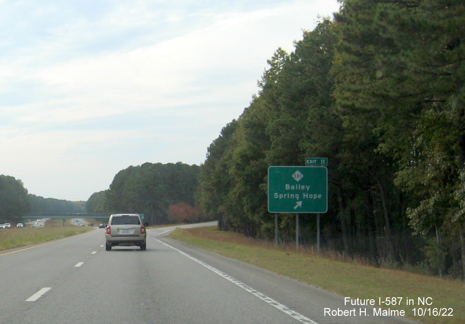 Image of ground mounted ramp sign for NC 581 exit on US 264 West with new Future I-587 mileage exit number, October 2022
