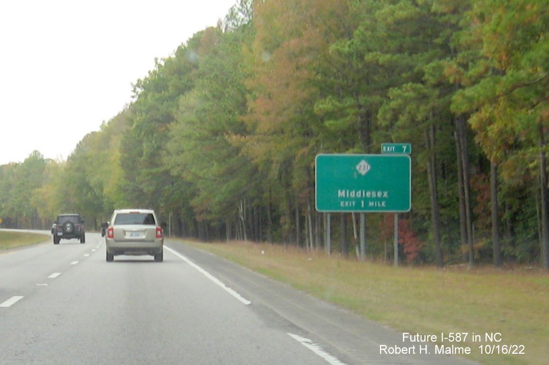 Image of ground mounted 1 mile advance sign for NC 231 exit on US 264 West in Middlesex with new Future I-587 mileage exit number, October 2022