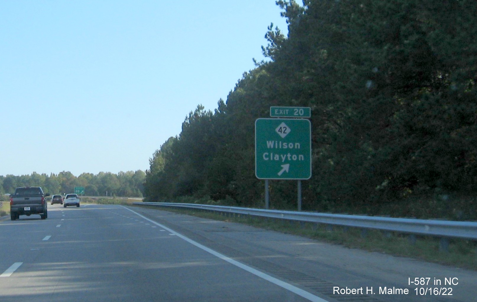 Image of ground mounted ramp sign for NC 42 exit with new I-587 milepost exit number on I-587/US 264 East,I-795 
                                        South in Wilson, October 2022