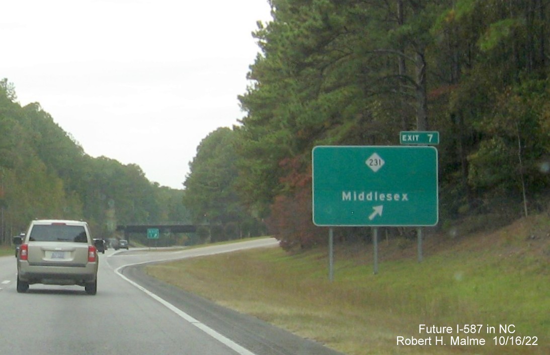Image of ground mounted ramp sign for NC 231 exit on US 264 West in Middlesex with new Future I-587 mileage exit number, October 2022