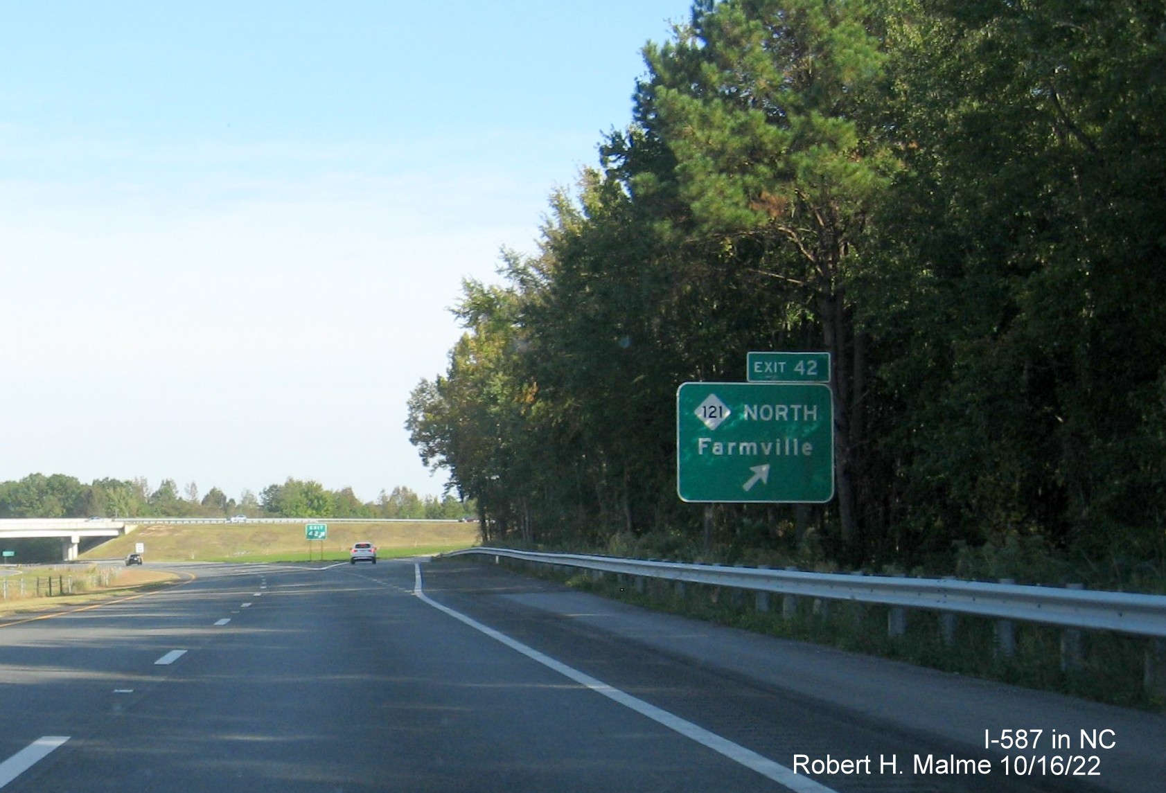 Image of ground mounted ramp sign for NC 121 North exit with new I-587 milepost exit number on I-587 East in Farmville, October 2022