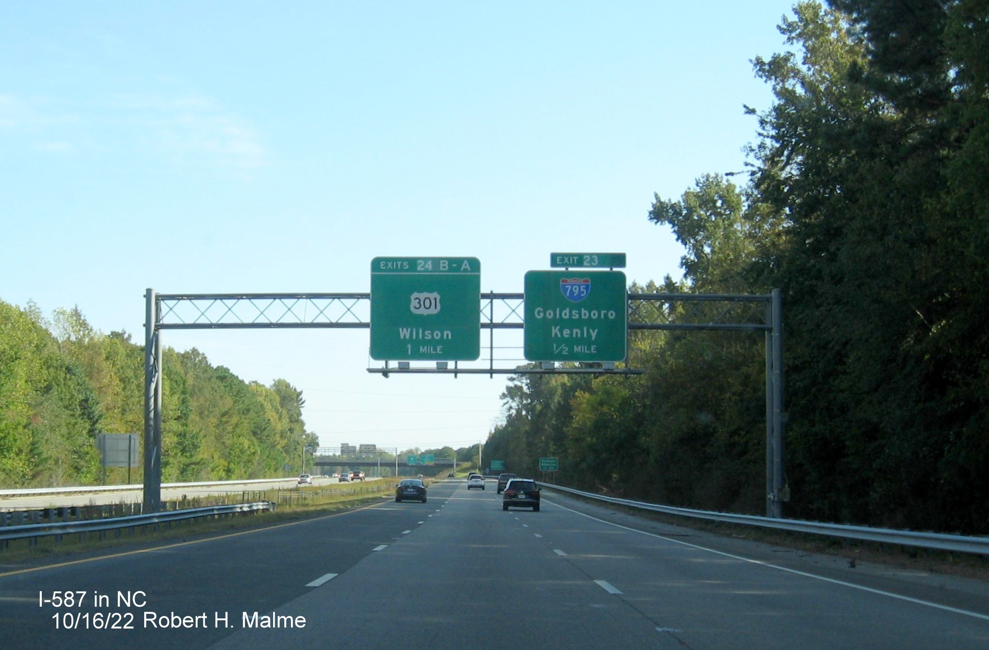 Image of 1/2 mile advance sign for NC 42 exit with new I-587 milepost exit number on I-587/US 264 East,I-795 
                                        South in Wilson, October 2022