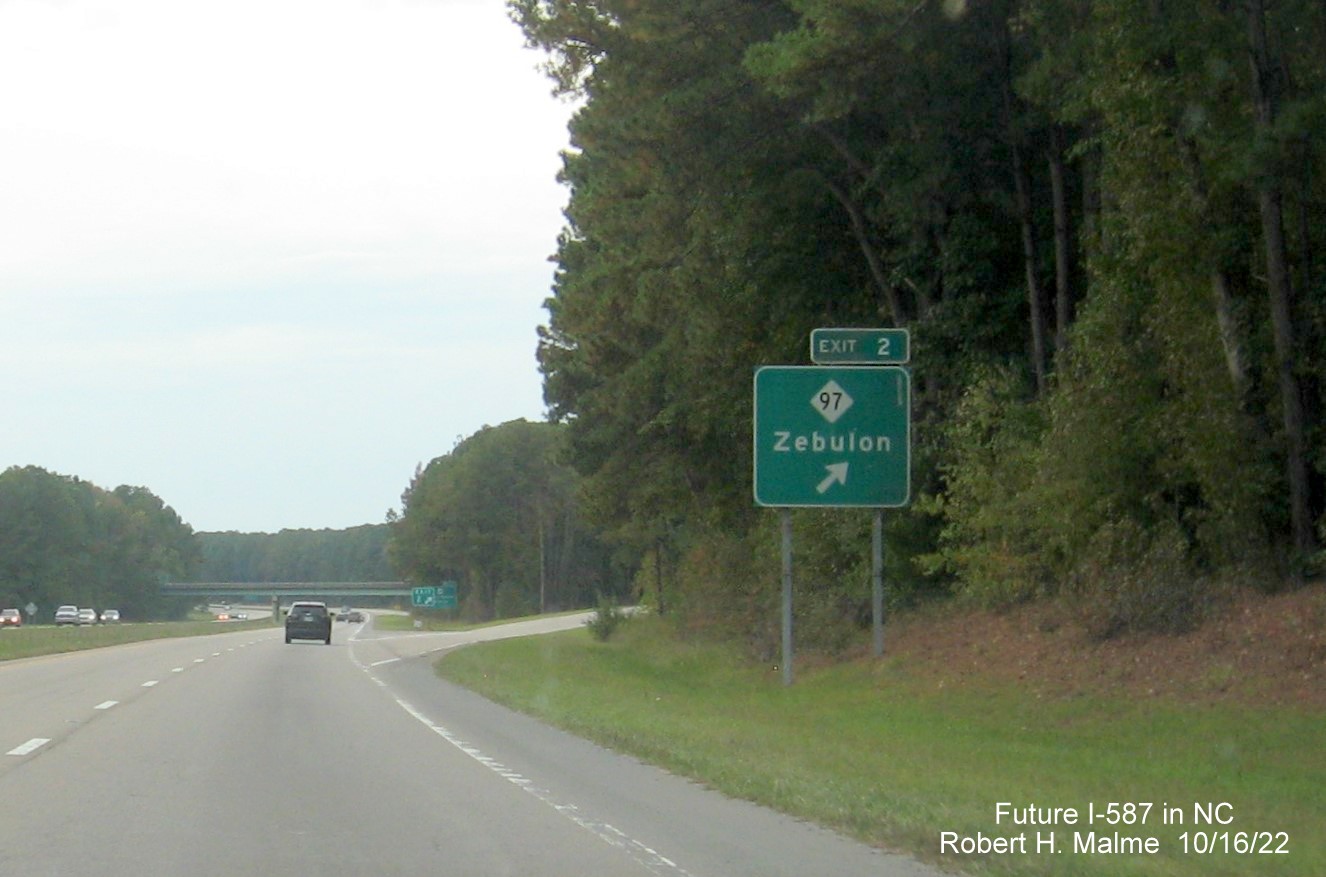 Image of ground mounted ramp sign for NC 97 exit with new Future I-587 mileage exit number, October 2022
