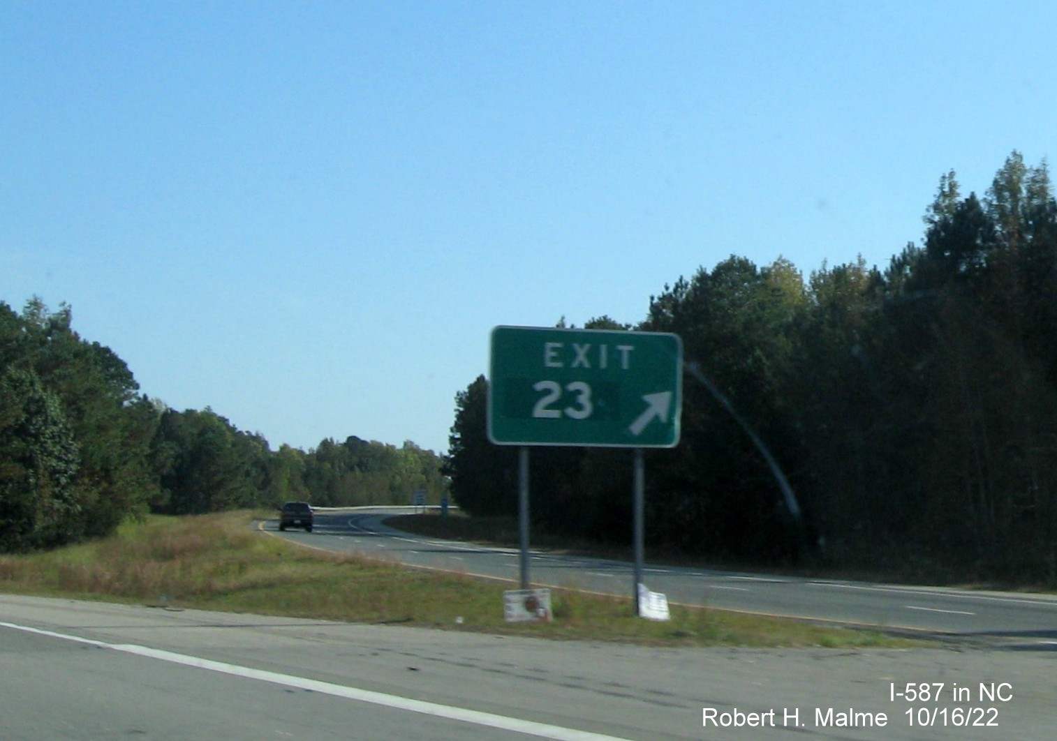 Image of gore sign for I-795 South exit with new I-587 milepost exit number on I-587/US 264 East in Wilson, October 2022