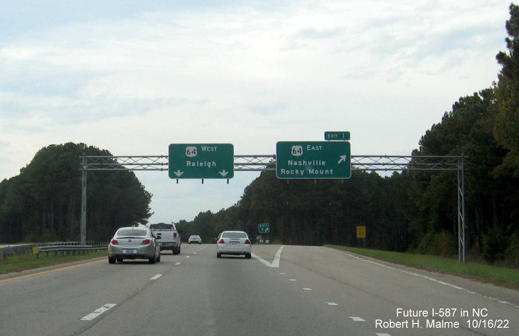 Image of overhead ramp sign for US 64 East exit with new Future I-587 mileage exit number, October 2022