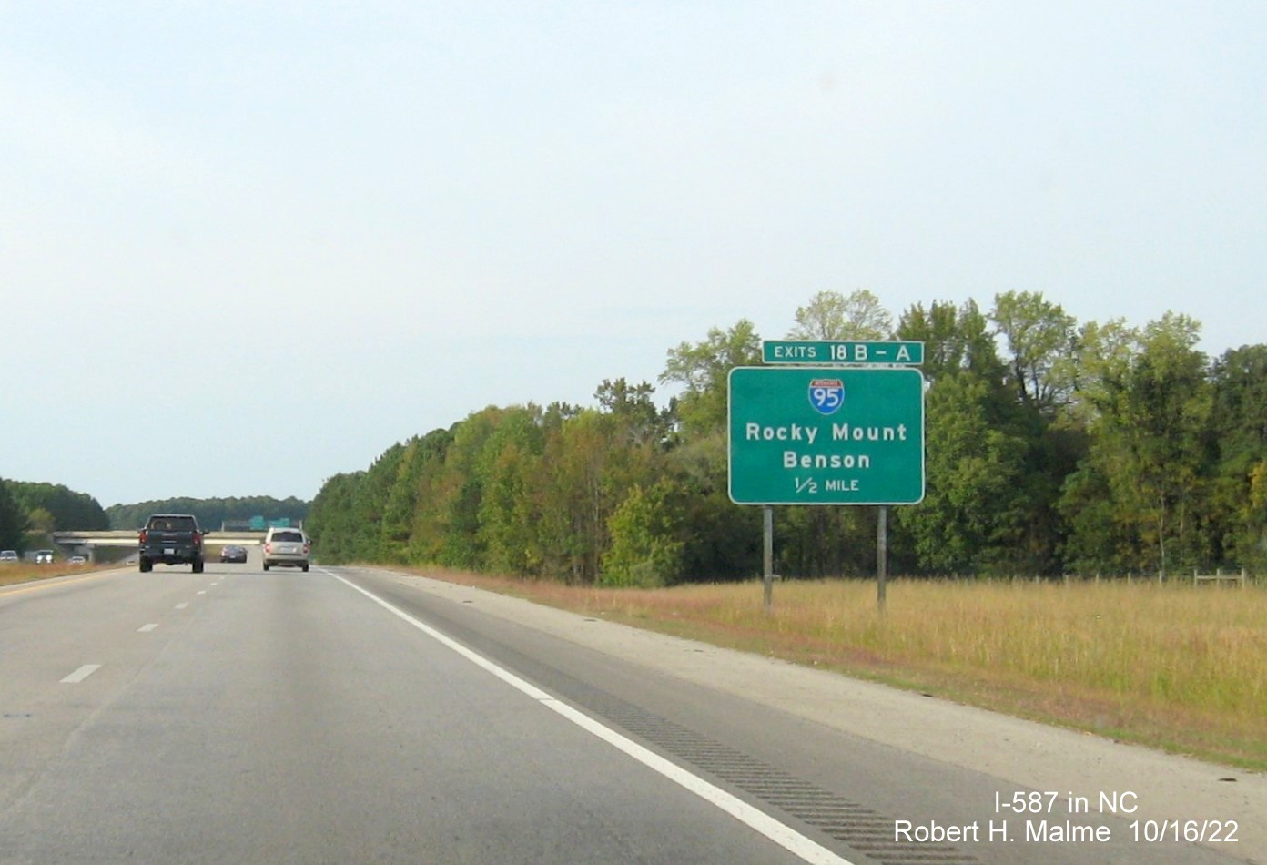 Image of ground mounted 1/2 mile advance sign for I-95 exits with new I-587 milepost exit numbers on I-587/US 264 West in Wilson, October 2022 