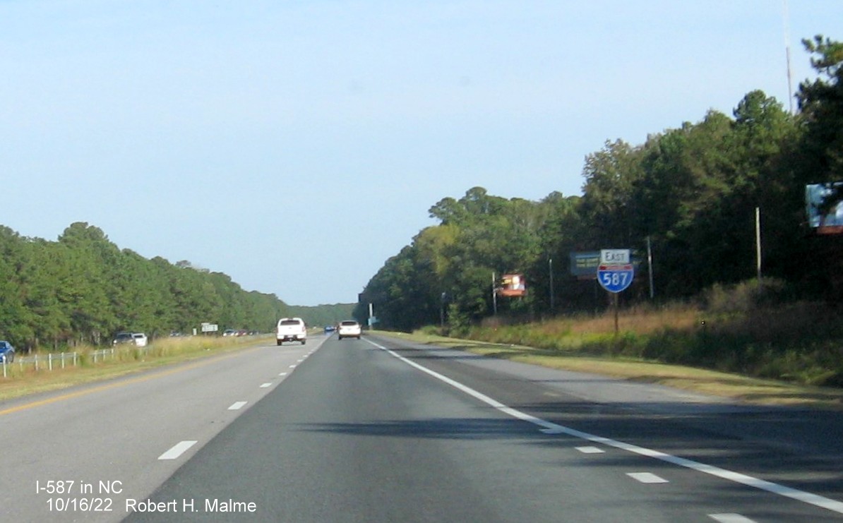 Image of 1 mile advance sign for US 264/NC 11 Bypass exits with new I-587 milepost exit number on I-587/US 264 East in Greenville, October 2022