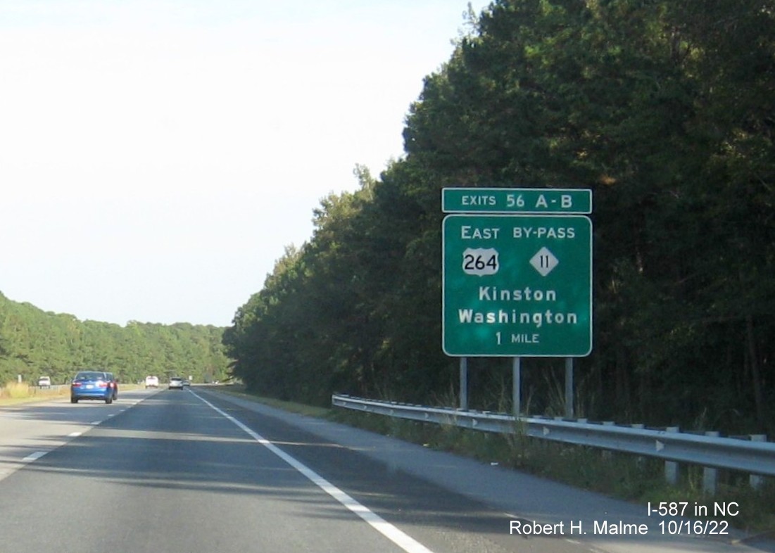 Image of overhead signage at ramp for US 264 West/NC 11 Bypass South exits, one with new I-587 milepost exit number on I-587/US 264 East in Greenville, October 2022