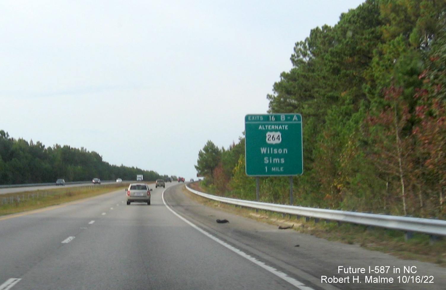 Image of ground mounted 1 mile advance sign for US 264 Alt. exits with new I-587 mile exit number on US 264 East in Sims, Google Maps Street View image, August 2022