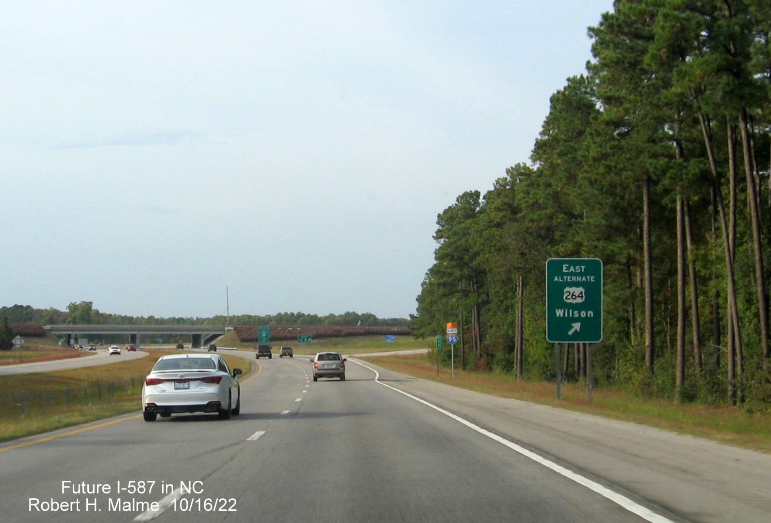 Image of ground mounted ramp sign for West US 264 Alt. exit with new I-587 mile exit number on US 264 East in Sims, Google Maps Street View image, August 2022