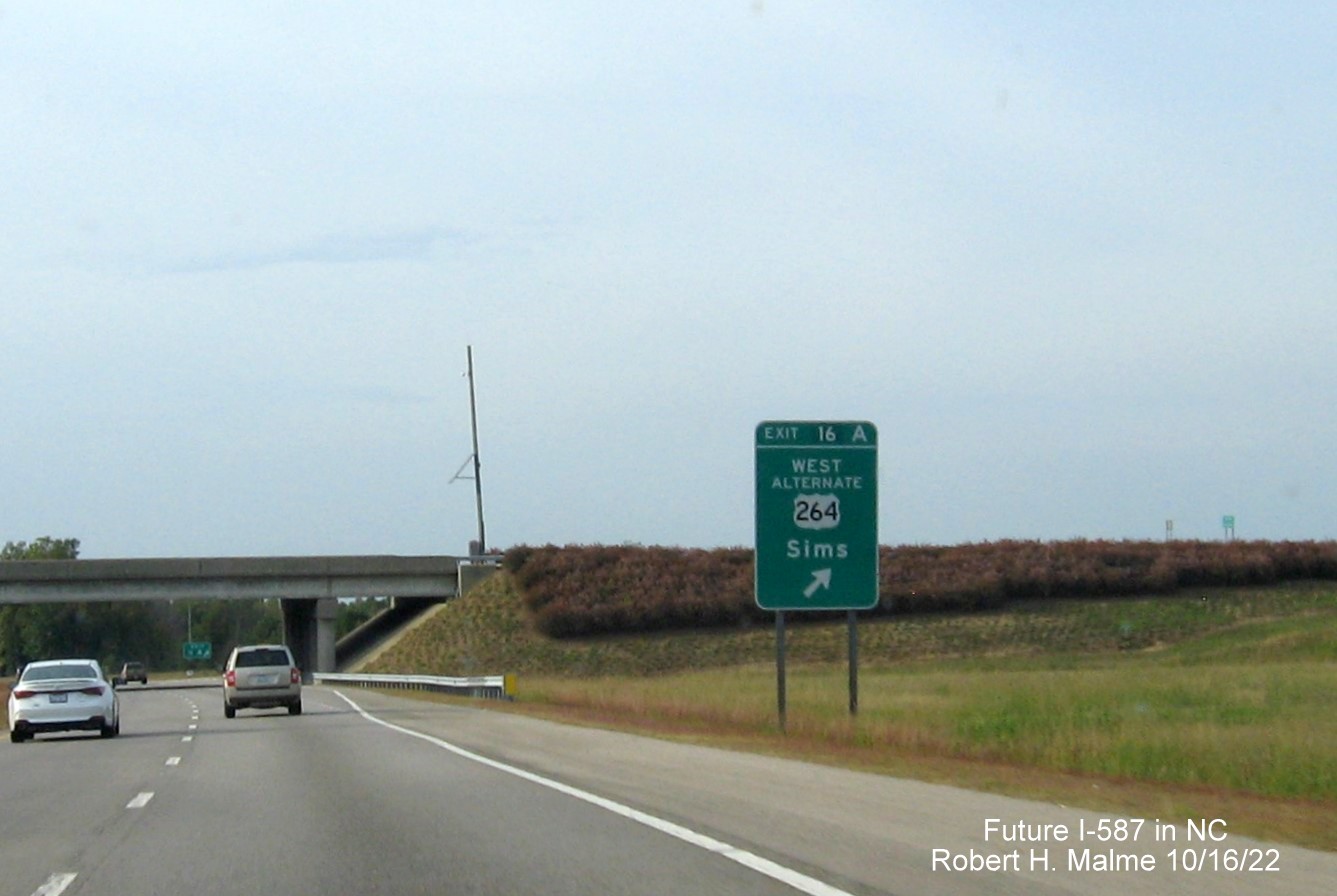 Image of ground mounted ramp sign for East US 264 Alt. exit with new I-587 milepost exit number on US 264 East in Sims, Google Maps Street View image, August 2022