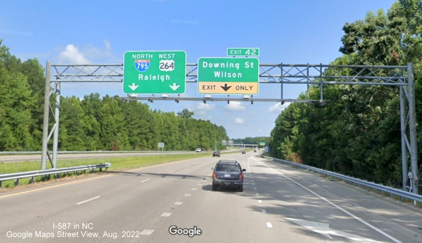 Image of overhead signage on I-587 West at Downing Street exit showing no update of exit number
      on I-587 West/I-795 North and US 264 West in Wilson, Google Maps Street View image, August 2022