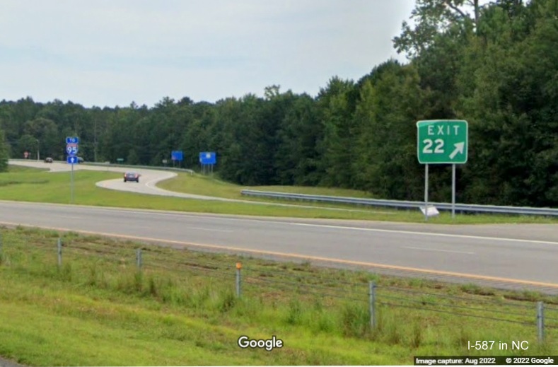 Image of gore sign for Downing Street exit with new I-587 exit number on I-587 West/I-795 North in Wilson, taken from opposite lanes, Google Maps Street View, August 2022