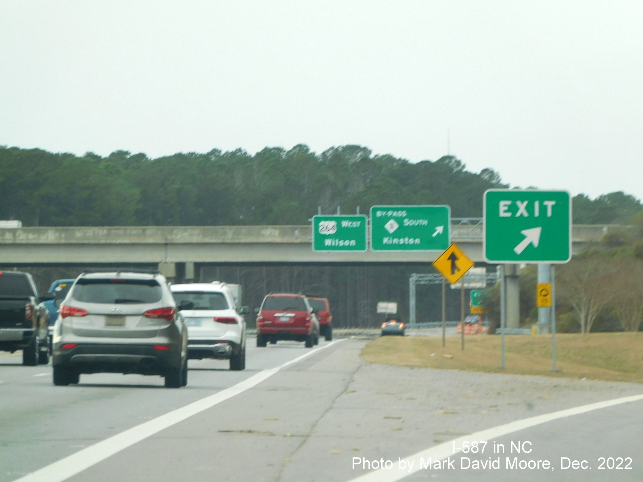 Image of overhead and gore sign for US 264 West/NC 11 Bypass North in Greenville at beginning of I-587 West, not on signs, photo by Mark David Moore, December 2022