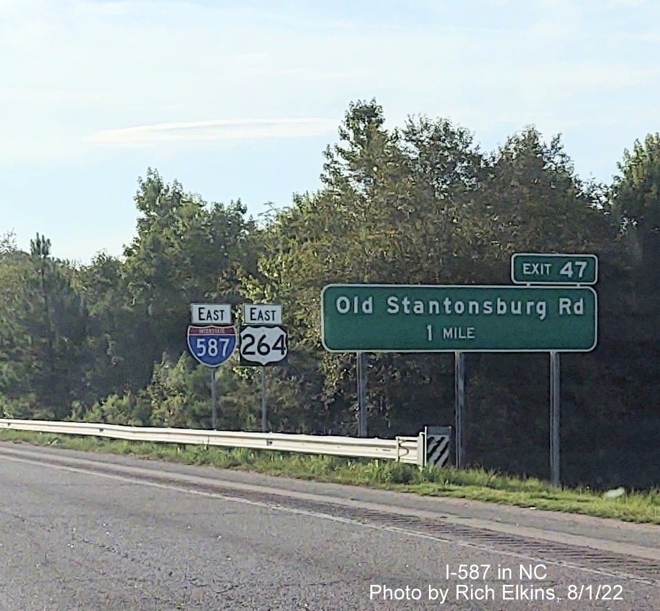 Image of new East I-587 reassurance marker in Wilson with US style direction banner, and unchanged 
      exit number on 1 mile advance sign for Old Stantonburg Road exit, photo courtesy of Rich Elkins, August 2022