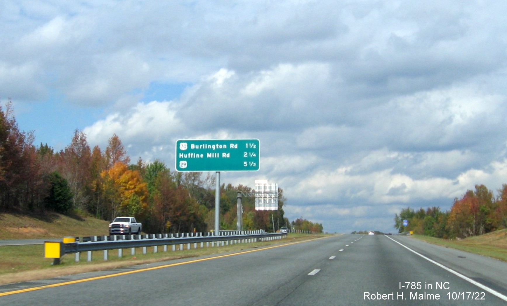 Image of overhead median post-interchange distance sign on I-785 North (Future I-840 West) Greensboro 
                  Urban Loop, October 2022
