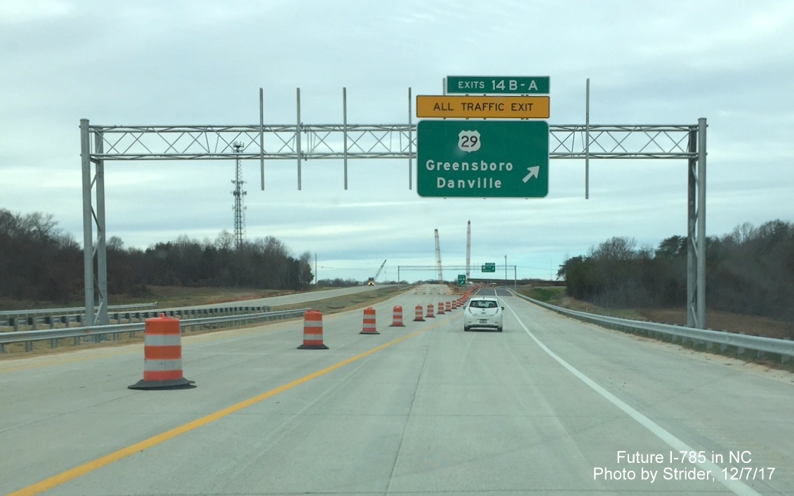 Image of overhead sign gantry on I-785 North/Greensboro Loop for US 29 exit, left side missing due to incomplete US 29 South ramp, by Strider