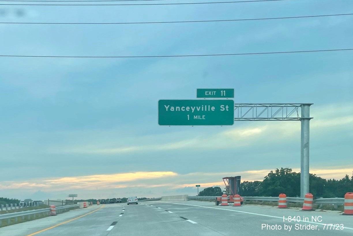 Image of newly placed 1 Mile advance overhead sign for Yanceyville Street exit on I-840/Greensboro Loop West, photo by Strider, July 2023