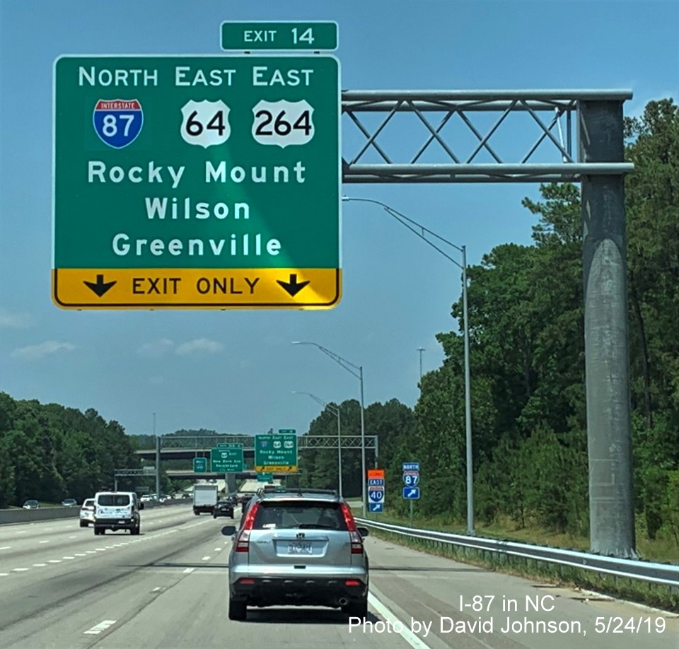 Image of new I-87 shield applied over I-495 shield on 1/2 mile advance overhead sign for Knightdale Bypass exit on I-87 North/I-440 West in Raleigh, by David Johnson