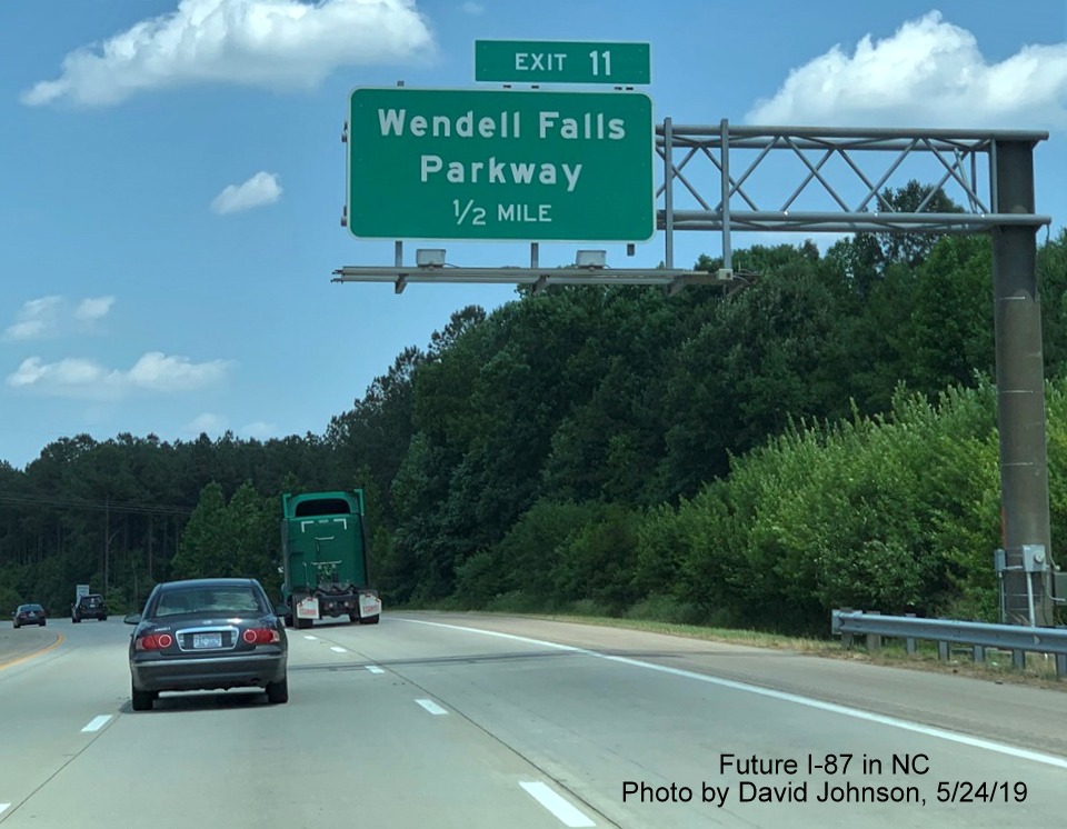 Image of 1/2 mile advance overhead sign for Wendell Falls Parkway exit with new I-87 exit number tab on I-87 North, US 64/264 East in Wendell, by David Johnson