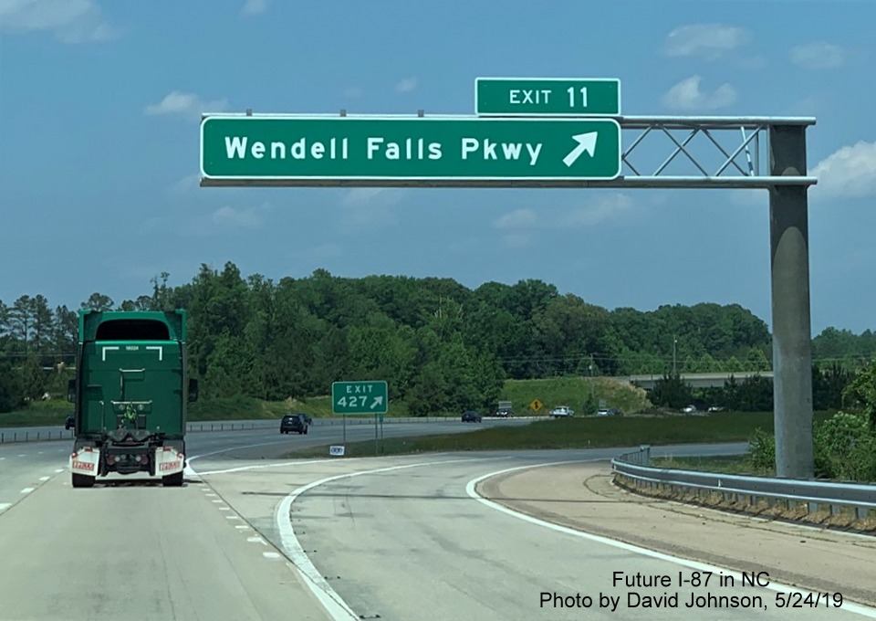 Image of overhead ramp sign for Wendell Falls Parkway exit with new I-87 exit number tab on I-87 North, US 64/264 East in Wendell, by David Johnson