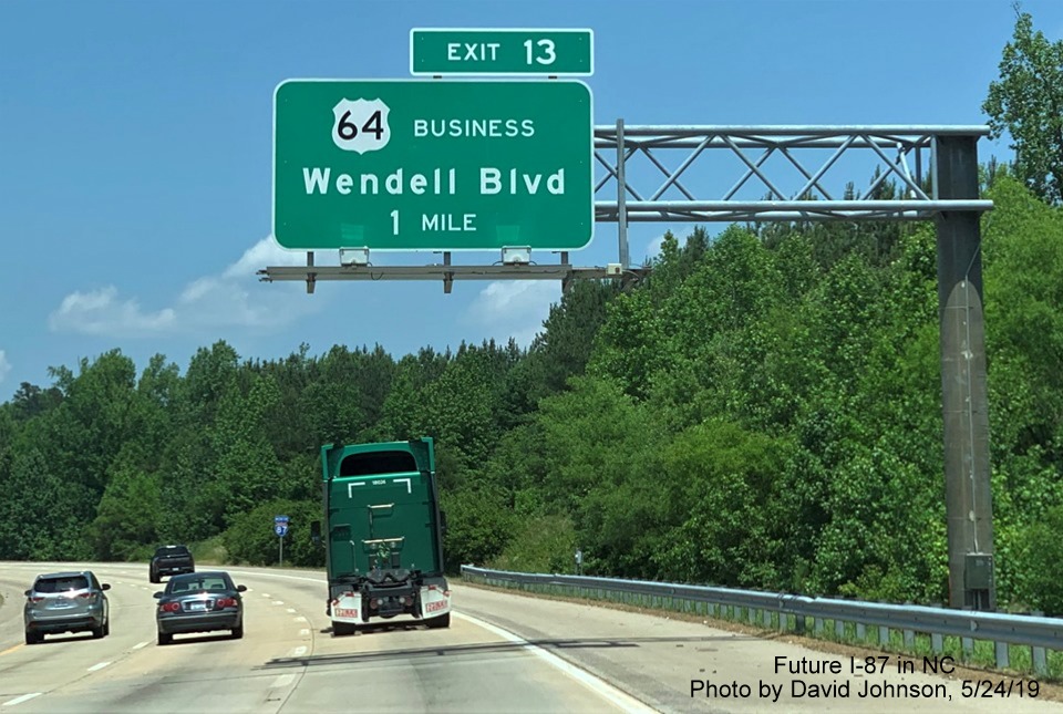 Image of 1-Mile advance sign for US 64 Business exit with new I-87 exit number tab on I-87 North, US 64/264 East in Wendell, by David Johnson