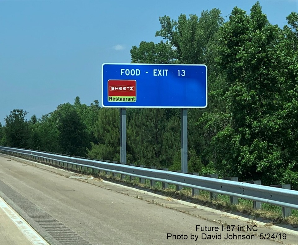Image of blue services sign for food available at US 64 Business exit in Wendell with new I-87 exit number on I-87 North, US 64/264 East in Wendell