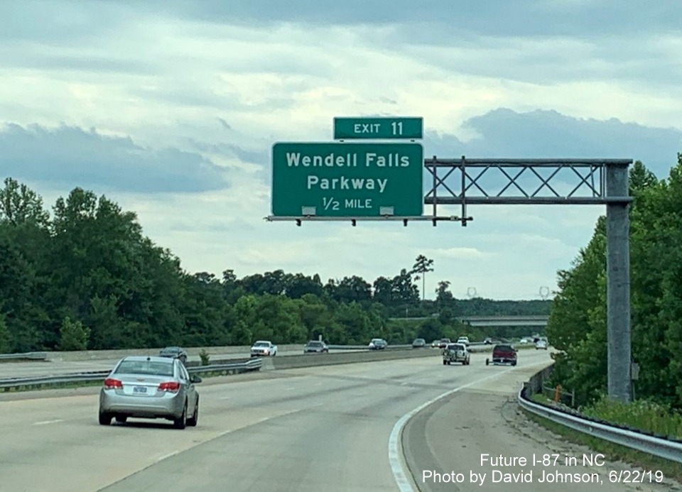 Image of overhead 1/2 mile advance sign for Wendell Falls Parkway with new I-87 exit number tab on I-87 South, US 64/264 West in Wendell, by David Johnson
