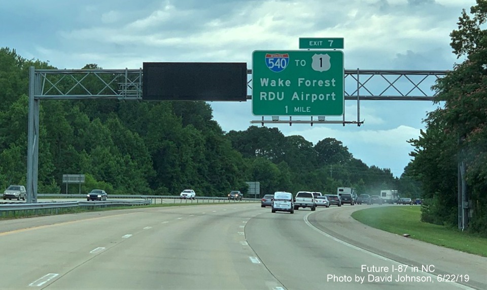 Image of overhead 1-mile advance sign for I-540 exit with new I-87 exit number tab on I-87 South, US 64/264 West in Knightdale, by David Johnson