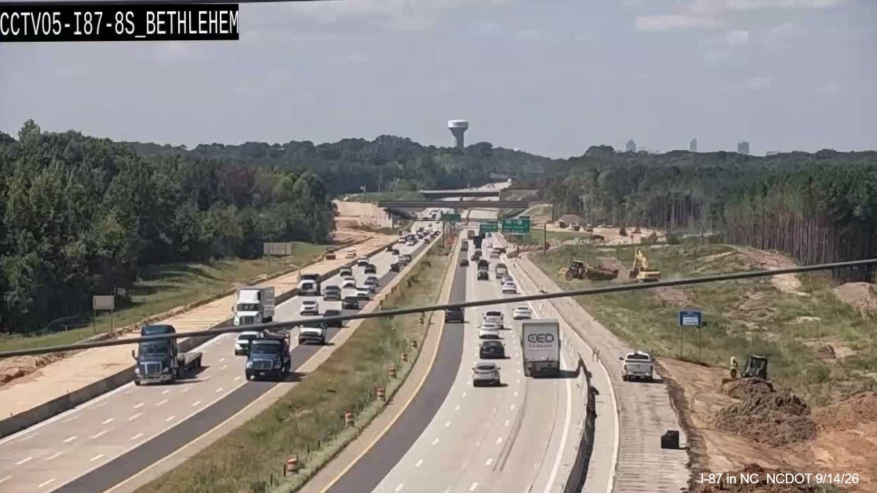 Image from NCDOT traffic camera of initial paving as part of pavement rehabilitation
		  project along East US 64/264 near mile marker 431, August 2026