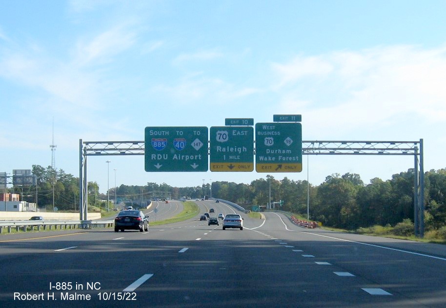 Image of overhead signage at ramp for US 70 Business West/NC 98 exit on I-885 South. US 70 East in Durham, October 2022