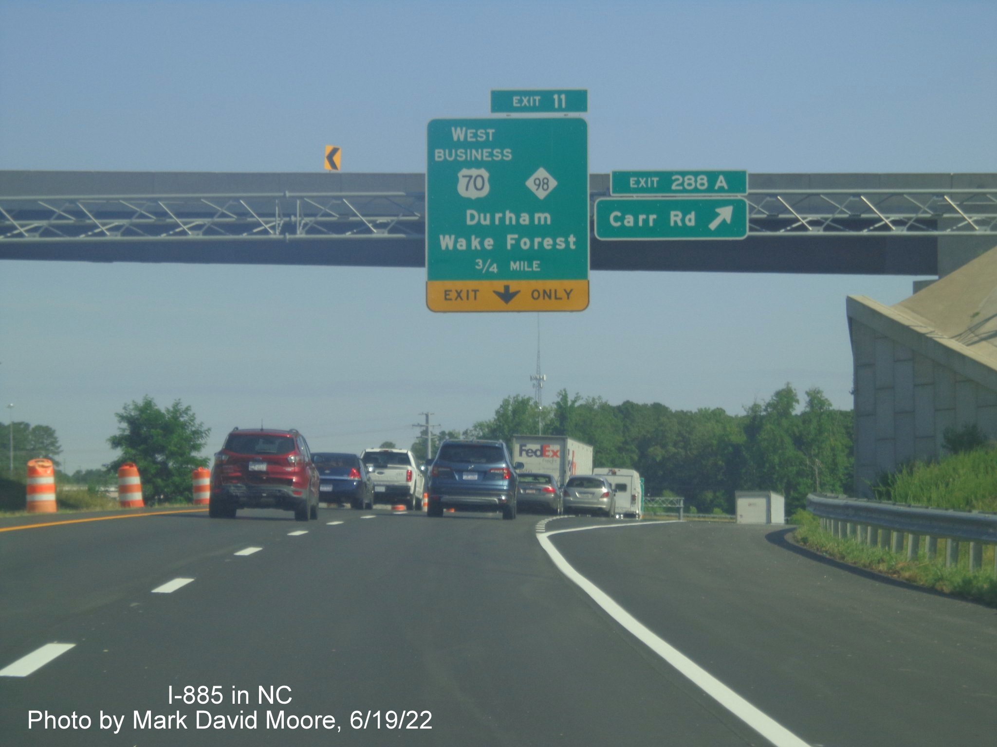 Image of exit sign with I-885 milepost on US 70 West in Durham, by Mark David Moore June 2022