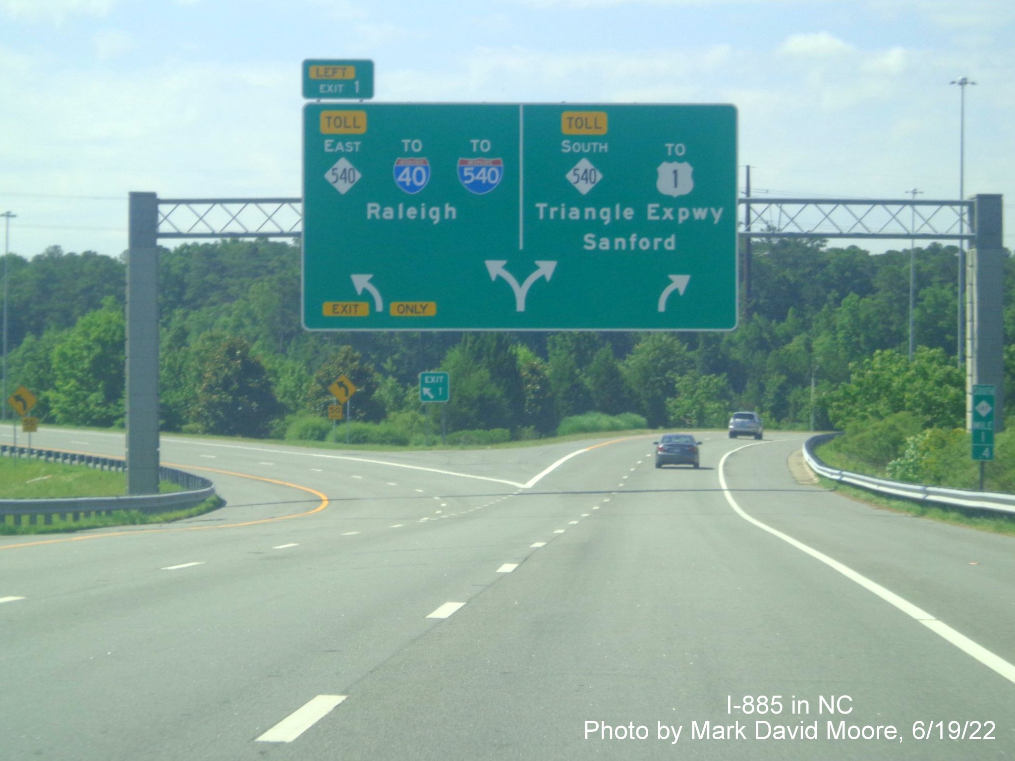 Image of overhead arrow-per-lane sign at the end of NC 885 at NC 540/
         Triangle Expressway in Wake County, by Mark David Moore June 2022