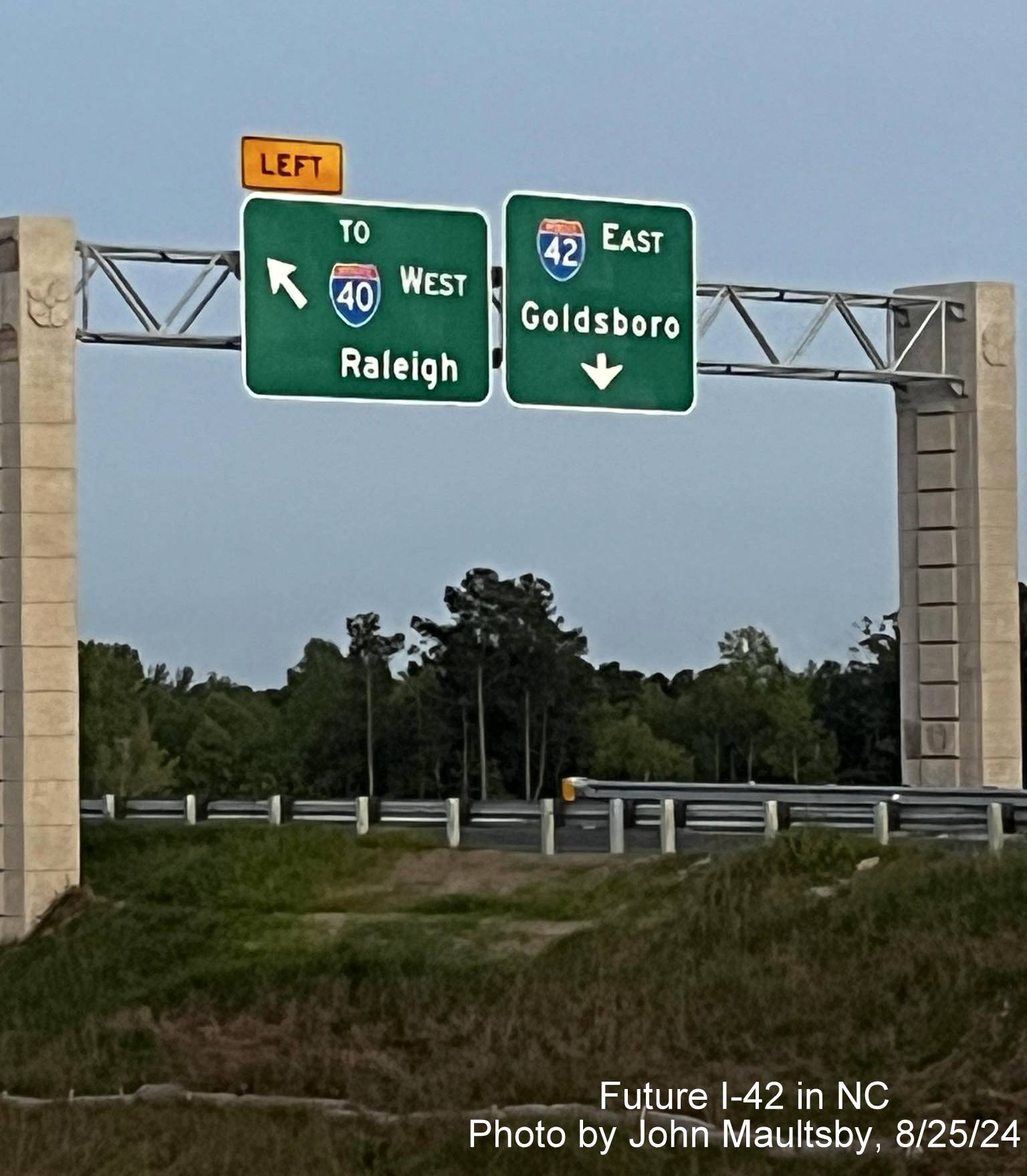 Image of new overhead sign with I-42 shield over unopened NC 540 Turbine Interchange ramp, by John Maultsby, August 2024