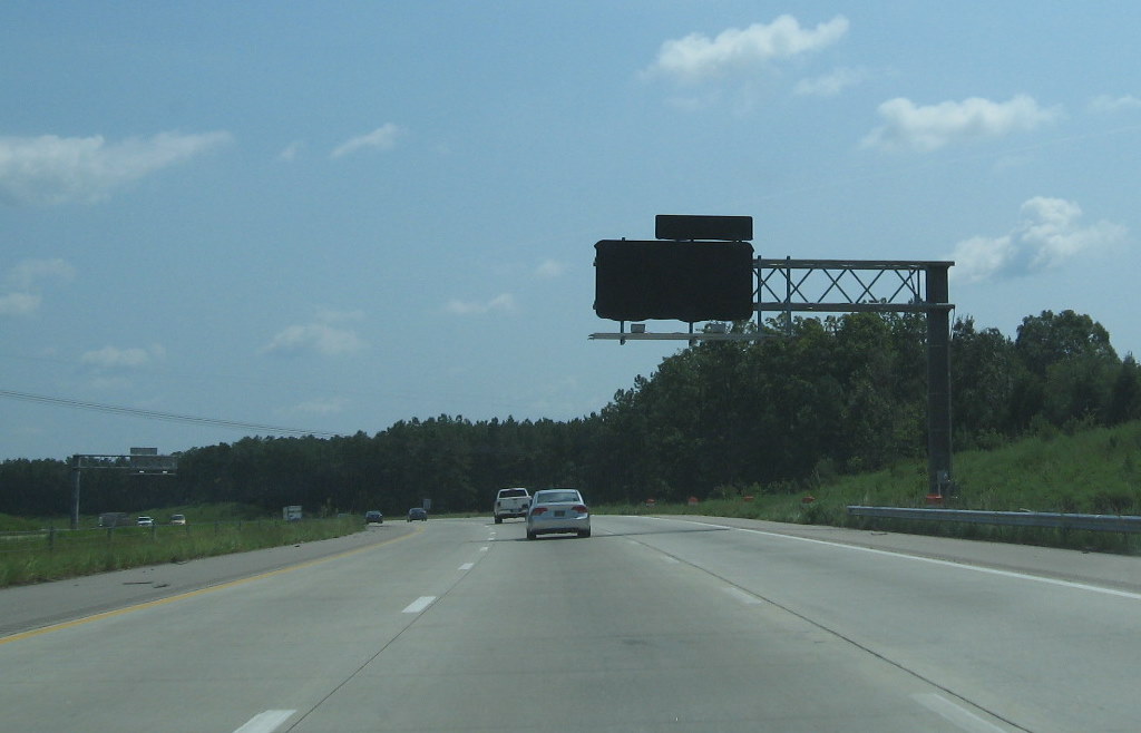 Photo of covered signage for new interchange with US 64/264 
in August 2009