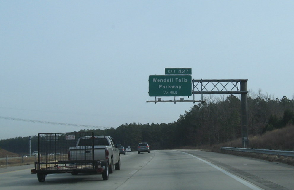 Photo of signage for Wendell Falls Parkway interchange with US 64/264 in 
January 2010